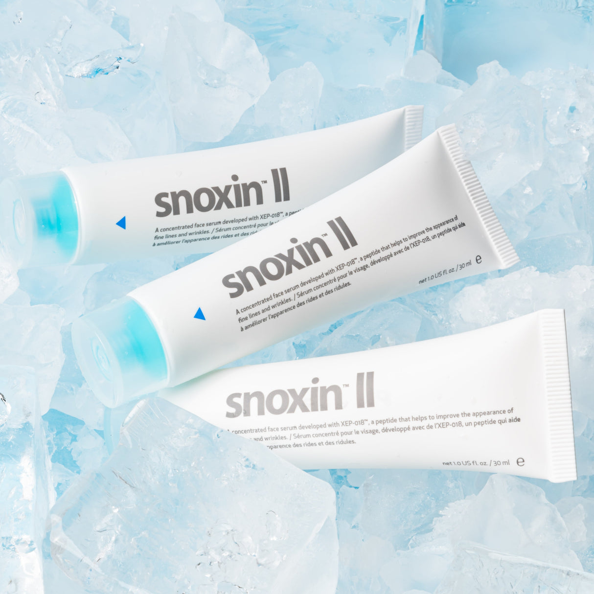 Three snoxin II tubes on a textured blue background